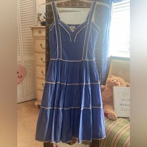 Blue polkadotted dress with a V-neck line and a lined linen skirt